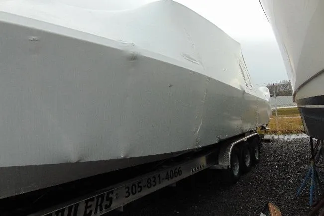 Slide: The Image of 2023 Nor-Tech 390 Sport Center Console boat covered on a trailer. - 12