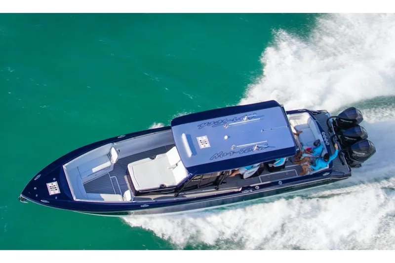 Slide: The Image of 2023 Nor-Tech 390 Sport Center Console interior with blue accents and modern design. - 18