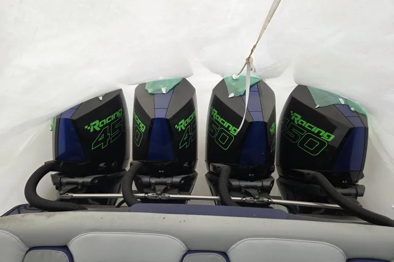 Slide: The Image of Four powerful outboard engines on a 2023 Nor-Tech 390 Sport Center Console boat. - 28