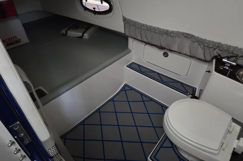 Slide: The Image of 2023 Nor-Tech 390 Sport Center Console cabin interior with toilet and storage. - 29