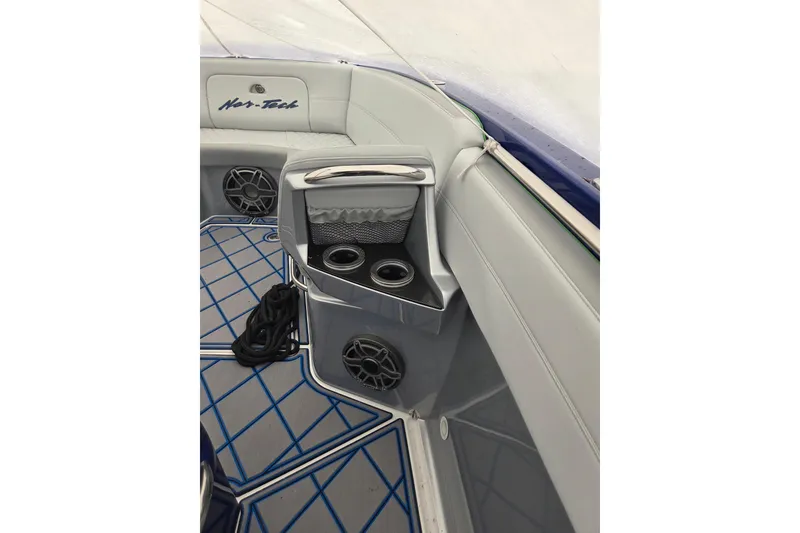 Slide: The Image of 2023 Nor-Tech 390 Sport Center Console interior with cup holders and speakers. - 31