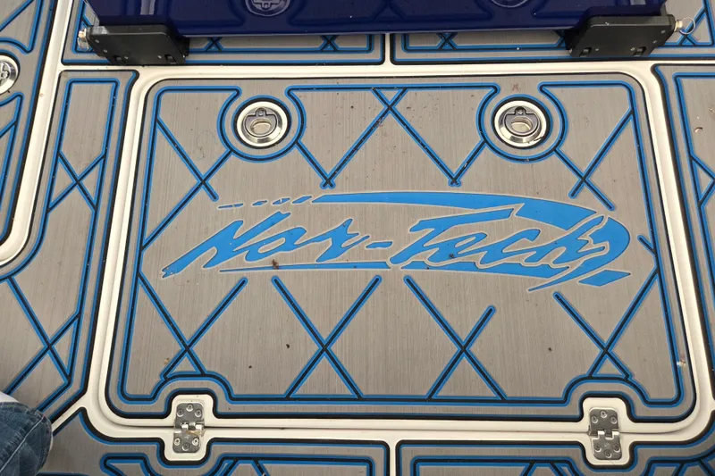 Slide: The Image of Nor-Tech 390 Sport Center Console 2023 deck with blue accents and logo. - 35