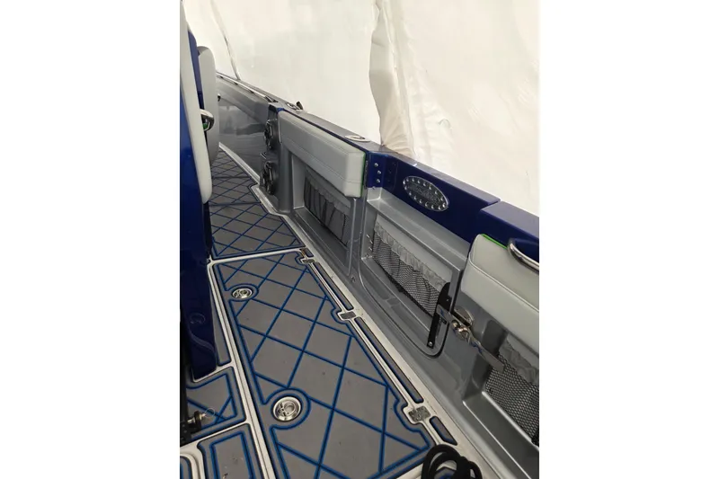 Slide: The Image of 2023 Nor-Tech 390 Sport Center Console interior with blue and gray flooring design. - 37