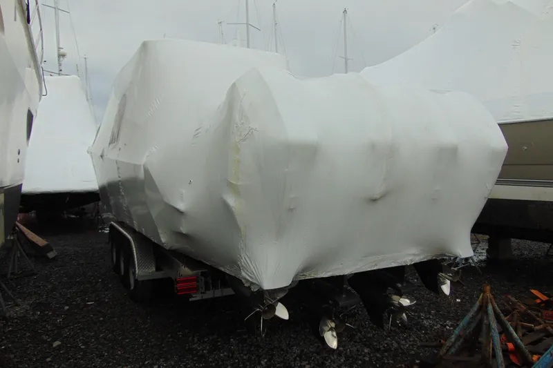 Slide: The Image of Covered 2023 Nor-Tech 390 Sport Center Console boat on trailer, stored outdoors. - 4
