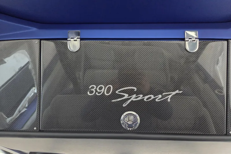 Slide: The Image of 2023 Nor-Tech 390 Sport Center Console with carbon fiber finish and secure latches. - 41