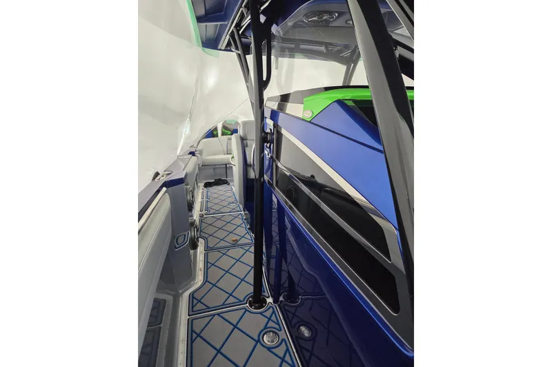 Slide: The Image of 2023 Nor-Tech 390 Sport Center Console, sleek blue and green interior design. - 43