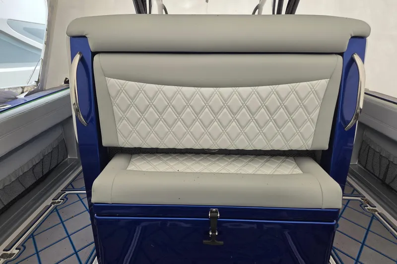 Slide: The Image of 2023 Nor-Tech 390 Sport Center Console interior with diamond-stitched seating and blue accents. - 46