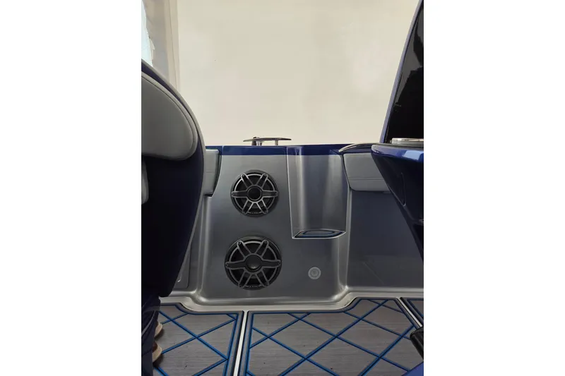 Slide: The Image of 2023 Nor-Tech 390 Sport Center Console interior with speakers and blue accents. - 48