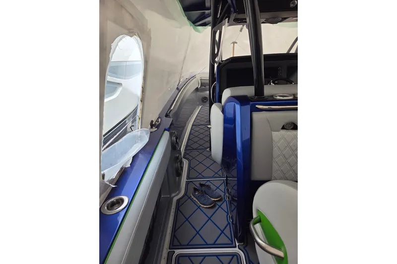 Slide: The Image of 2023 Nor-Tech 390 Sport Center Console interior with blue and white seating, modern design. - 49