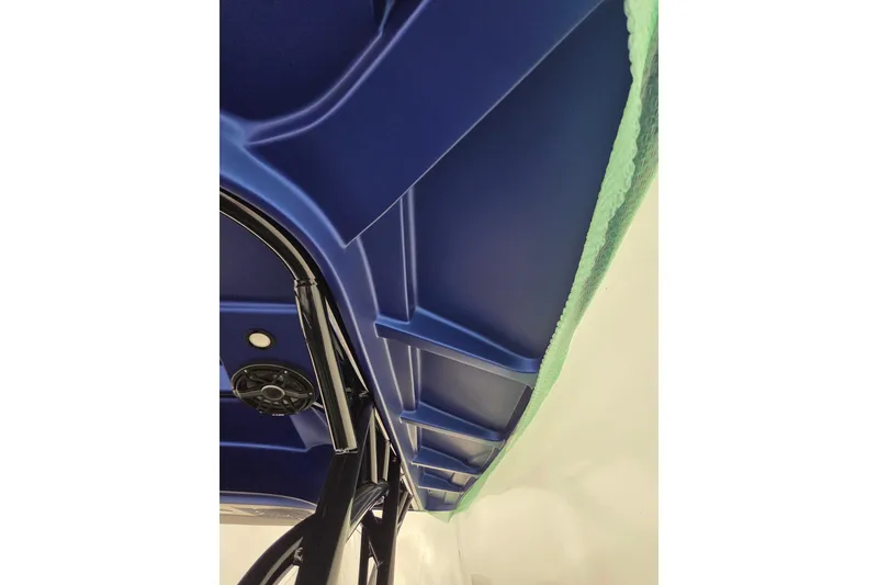 Slide: The Image of 2023 Nor-Tech 390 Sport Center Console, blue interior detail with speaker and structural elements. - 50