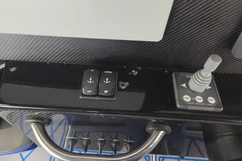 Slide: The Image of Control panel of 2023 Nor-Tech 390 Sport Center Console with switches and joystick. - 51