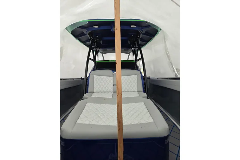 Slide: The Image of 2023 Nor-Tech 390 Sport Center Console interior with cushioned seating under a canopy. - 55