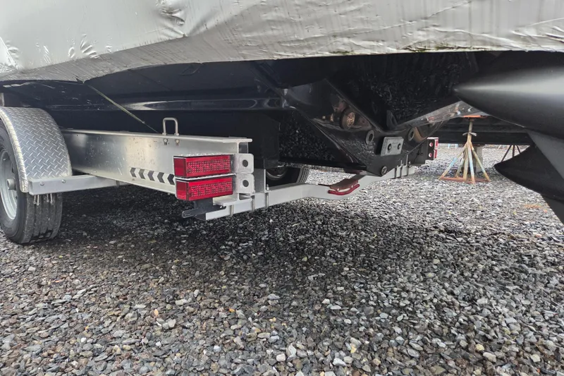 Slide: The Image of Trailer for 2023 Nor-Tech 390 Sport Center Console on gravel surface. - 56