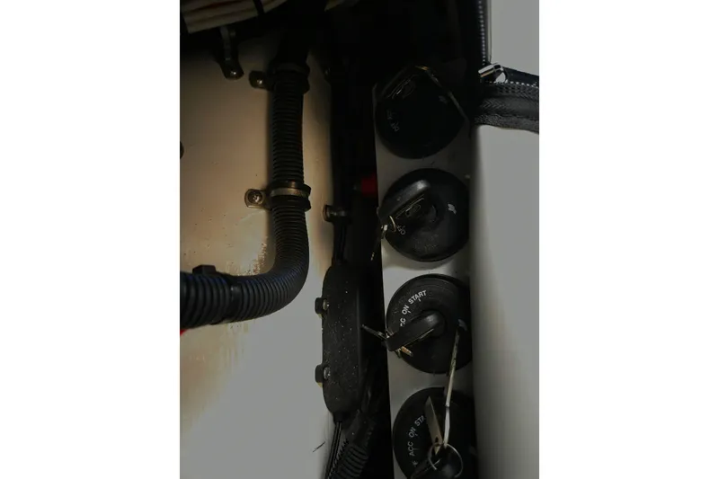 Slide: The Image of Control panel of 2023 Nor-Tech 390 Sport Center Console boat with wiring and switches. - 59