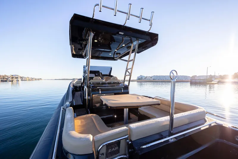 Slide: The Image of 2020 Zar Formenti 95 SL boat on calm water, featuring spacious seating and sleek design. - 16