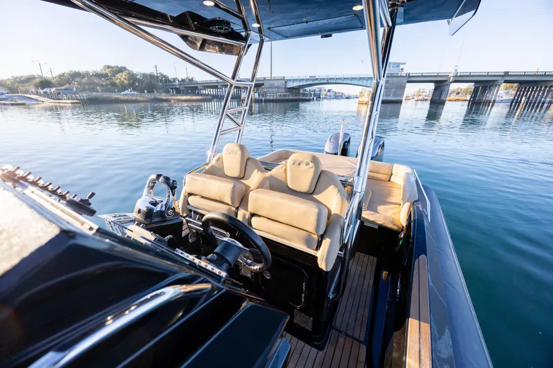 Slide: The Image of 2020 Zar Formenti 95 SL boat interior with steering wheel, seats, and scenic water view. - 23