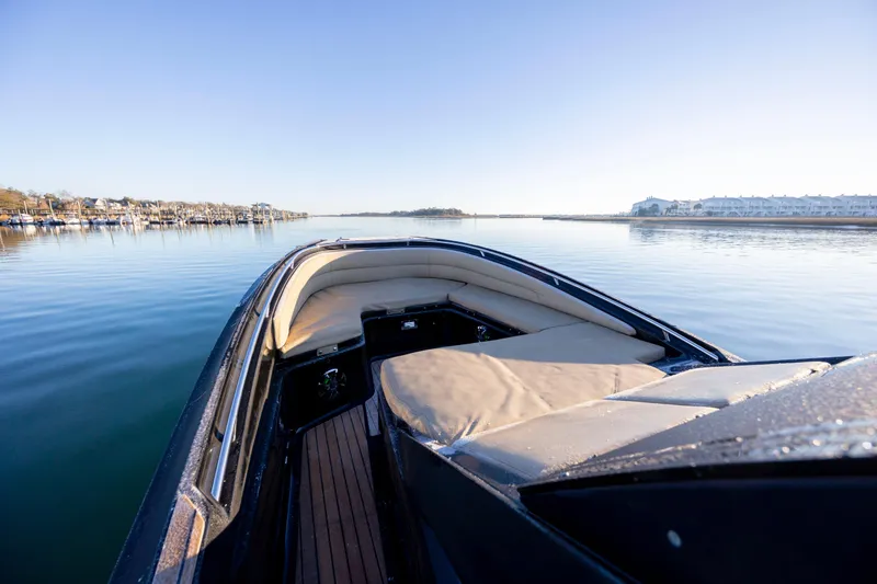 Slide: The Image of 2020 Zar Formenti 95 SL boat on calm water, featuring spacious seating and sleek design. - 24