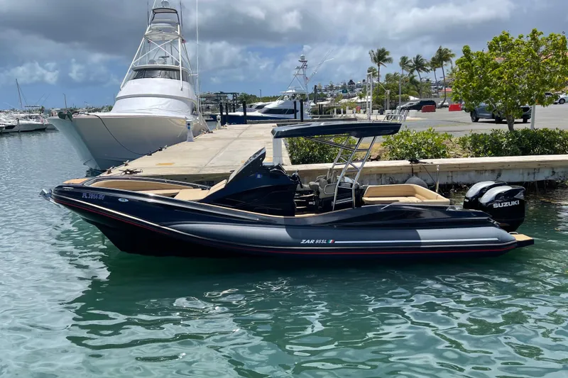 Slide: The Image of Zar Formenti 95 SL 2020 boat on calm water, scenic marina background. - 5