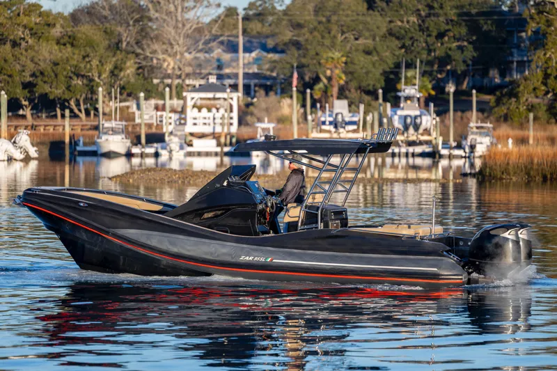 Slide: The Image of 2020 Zar Formenti 95 SL boat cruising on a calm waterway with scenic background. - 8
