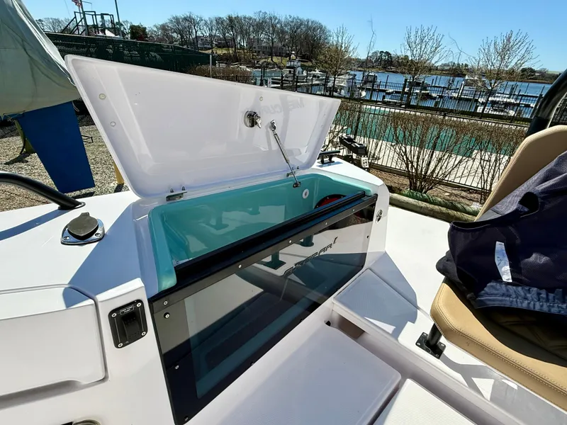 Slide: The Image of 2021 Axopar 37 boat with open storage compartment, dockside view. - 17