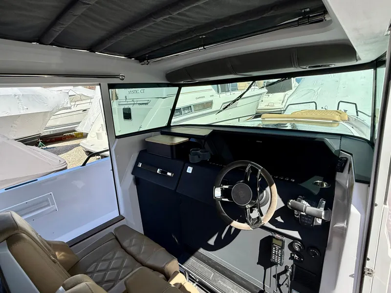 Slide: The Image of Interior of a 2021 Axopar 37 boat, featuring a modern steering console. - 22