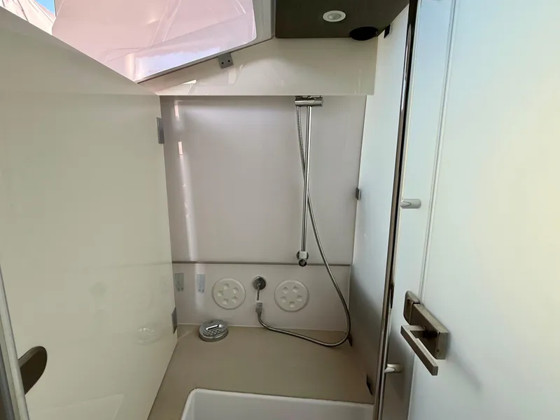 Slide: The Image of Interior view of 2021 Axopar 37 boat bathroom with shower and modern fixtures. - 25