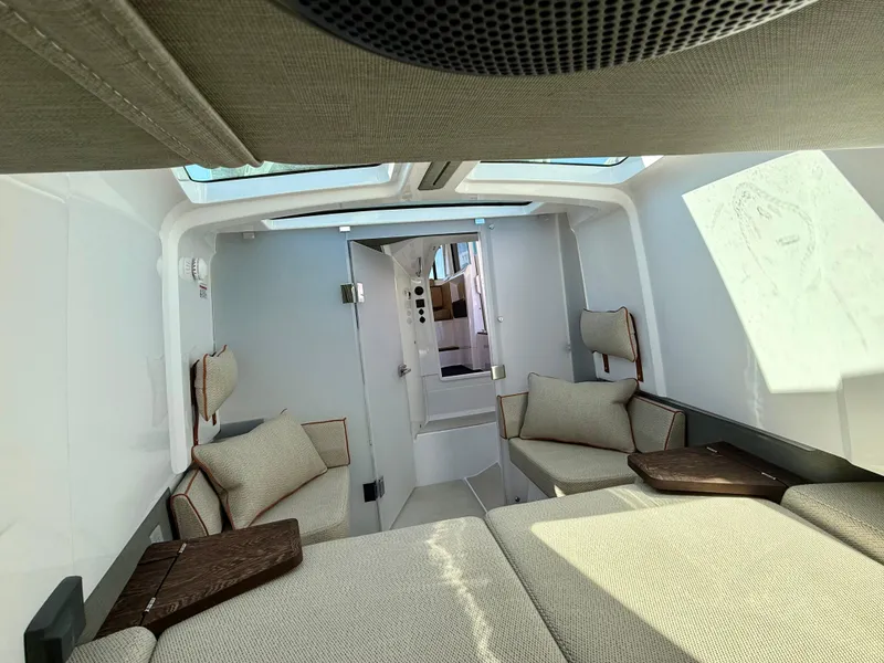 Slide: The Image of Interior of 2021 Axopar 37 boat, featuring modern seating and natural light. - 28