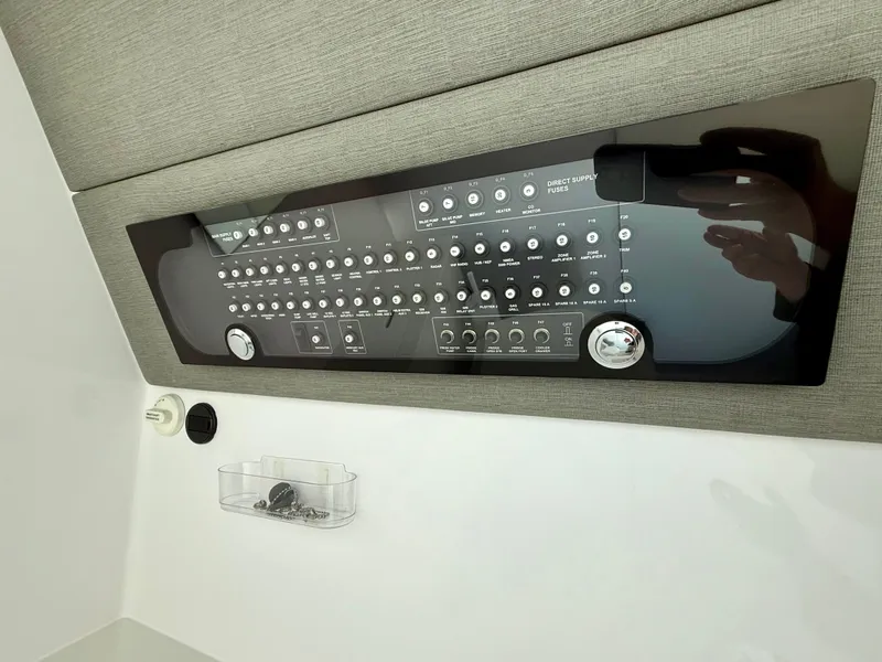 Slide: The Image of Control panel of a 2021 Axopar 37 boat, featuring various switches and dials. - 29