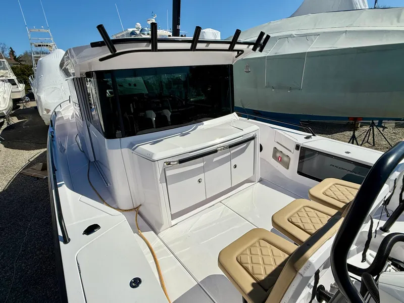 Slide: The Image of 2021 Axopar 37 boat with seating and storage, docked outdoors. - 8