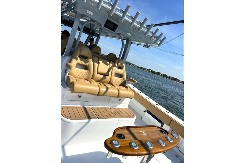 Slide: The Image of Luxurious seating on a 2026 Freeman 47 boat, featuring tan leather and ocean backdrop. - 14