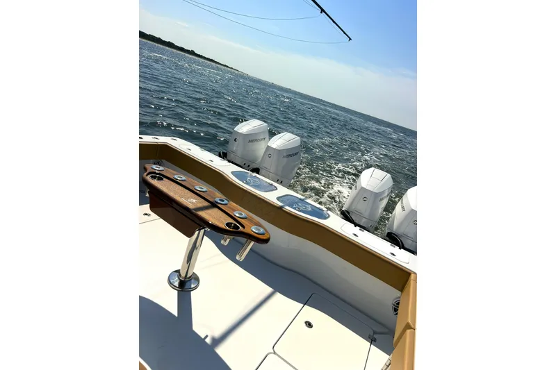 Slide: The Image of Freeman 47 boat, 2026 model, with multiple outboard engines on open water. - 15