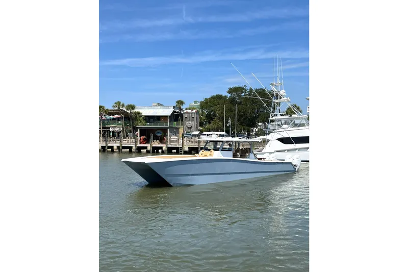 Slide: The Image of 2026 Freeman 47 boat docked in a marina under a clear blue sky. - 3
