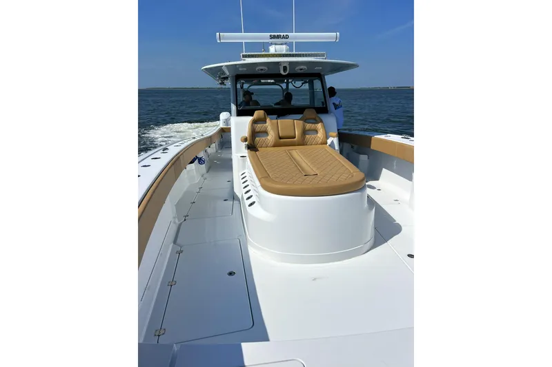 Slide: The Image of 2026 Freeman 47 boat with tan seating, cruising on open water. - 7