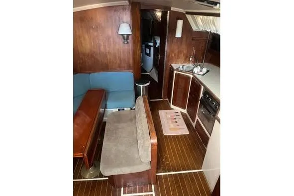 Slide: The Image of Interior of 1989 Catalina 42 sailboat with wood paneling and compact kitchen area. - 15
