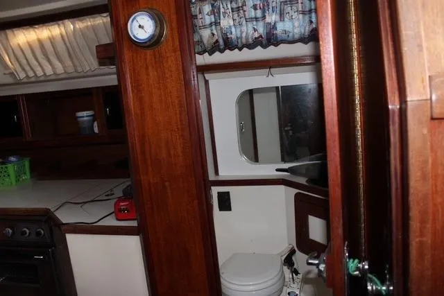 Slide: The Image of Interior of 1989 Catalina 42 sailboat with wooden cabinetry and compact bathroom. - 18