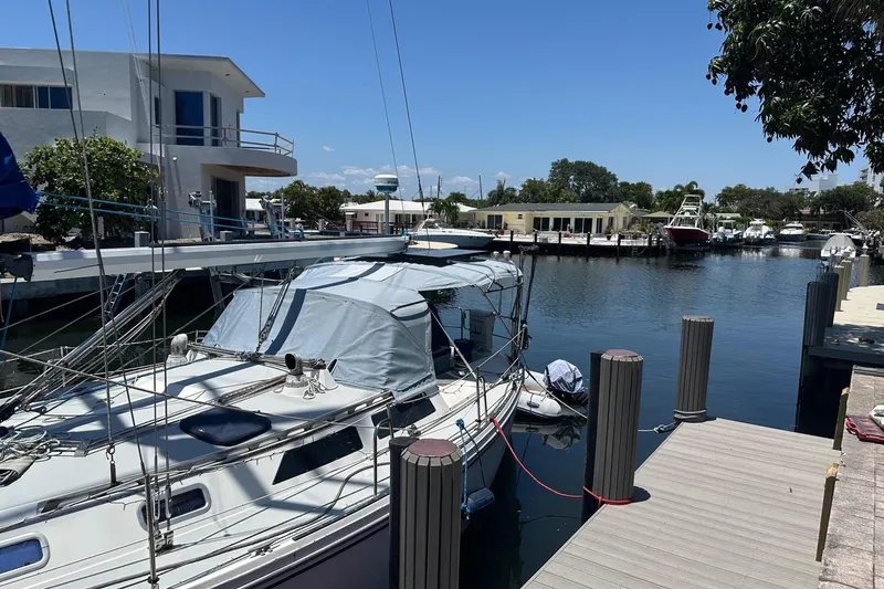 The Image of 1989 Catalina 42 sailboat docked in a serene marina setting. - 2