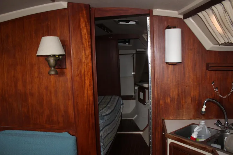 Slide: The Image of Interior of 1989 Catalina 42 sailboat with wood paneling and compact kitchen area. - 30