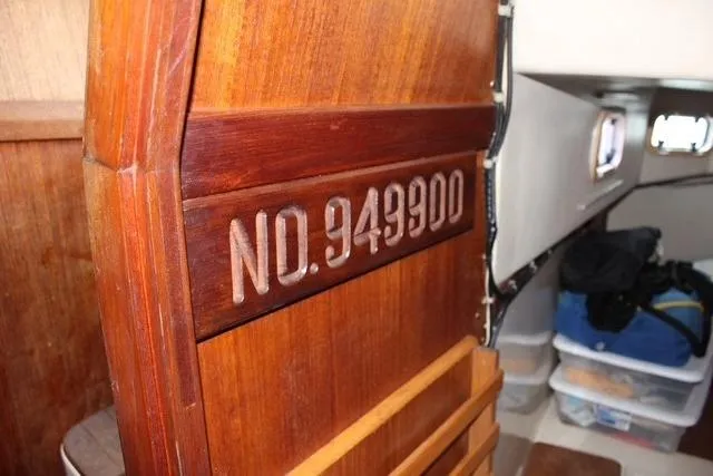 Slide: The Image of Interior of 1989 Catalina 42 sailboat with wooden paneling and storage area. - 46