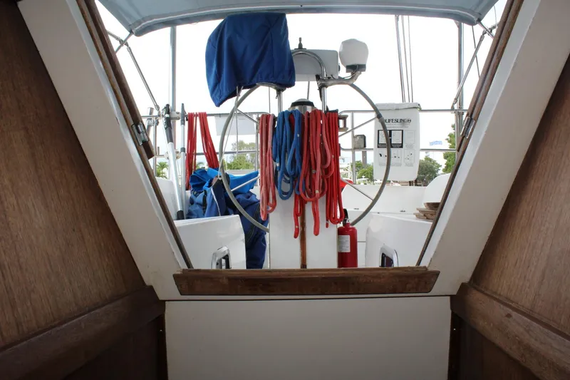 Slide: The Image of Cockpit view of 1989 Catalina 42 sailboat with ropes and steering wheel. - 49