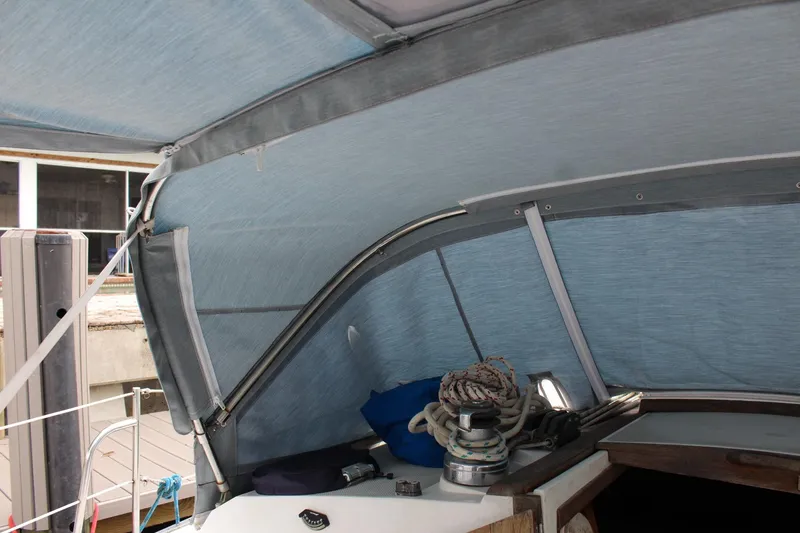 Slide: The Image of Interior view of a 1989 Catalina 42 sailboat cockpit with blue canopy and winch. - 50