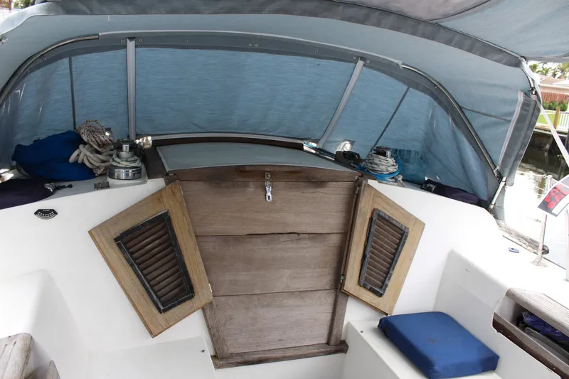 Slide: The Image of Cockpit of 1989 Catalina 42 sailboat with wooden hatch and blue canopy. - 52