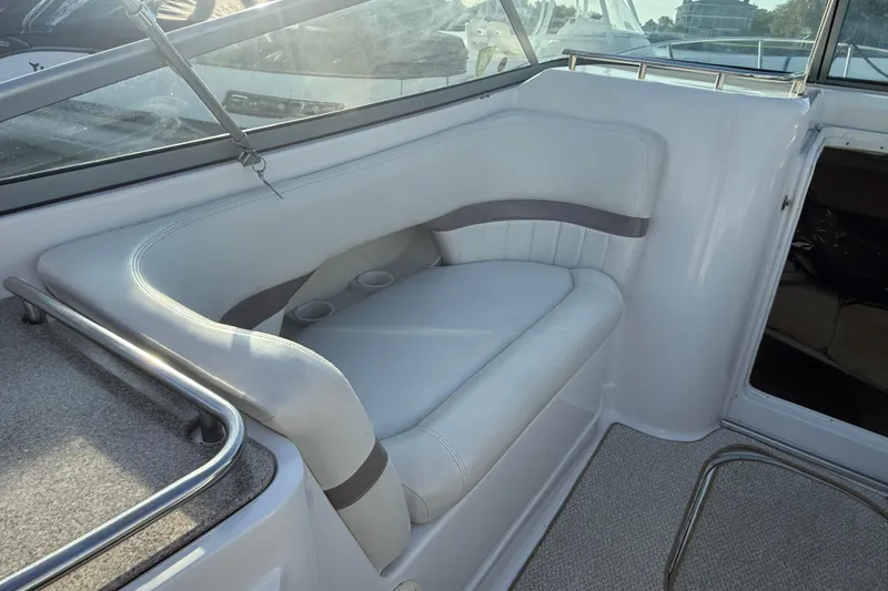 Slide: The Image of 2003 Four Winns 285 Sundowner boat interior with cushioned seating and cup holders. - 3
