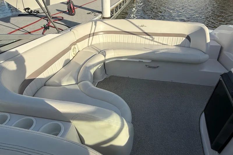 Slide: The Image of 2003 Four Winns 285 Sundowner boat interior with plush seating and cup holders. - 5