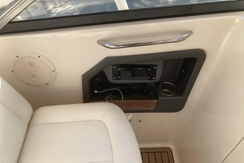 Slide: The Image of Interior of 2015 Grady-White Freedom 275 boat with control panel and seating. - 14