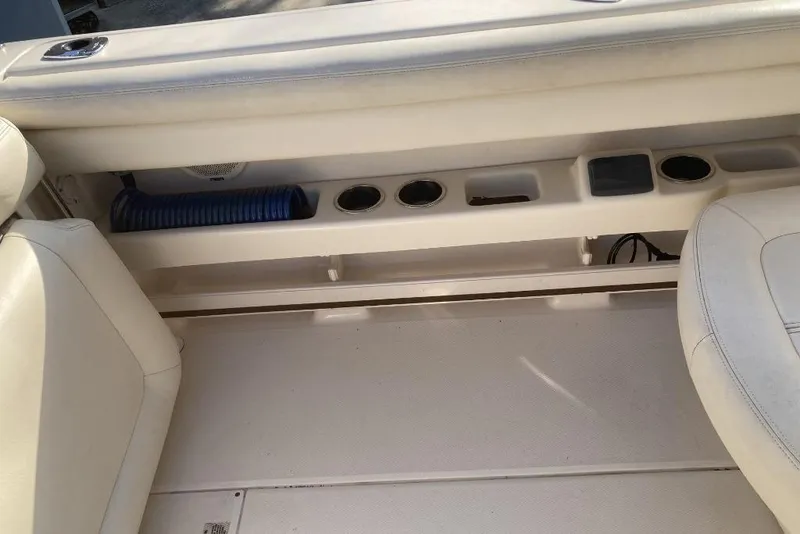 Slide: The Image of Interior of 2015 Grady-White Freedom 275 boat, featuring seating and storage compartments. - 18