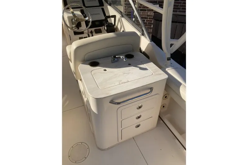 Slide: The Image of 2015 Grady-White Freedom 275 boat interior with helm and storage compartments. - 9