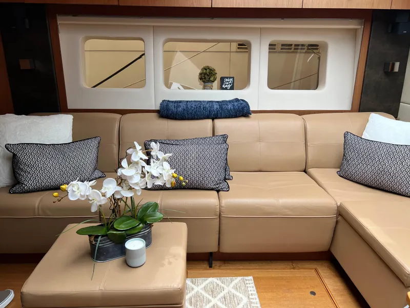 Slide: The Image of Luxurious interior of 2014 Sea Ray 510 Sundancer with beige leather seating and decorative pillows. - 14