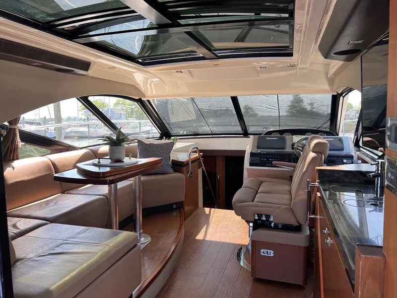 Slide: The Image of Luxurious interior of 2014 Sea Ray 510 Sundancer yacht with plush seating and modern helm. - 18