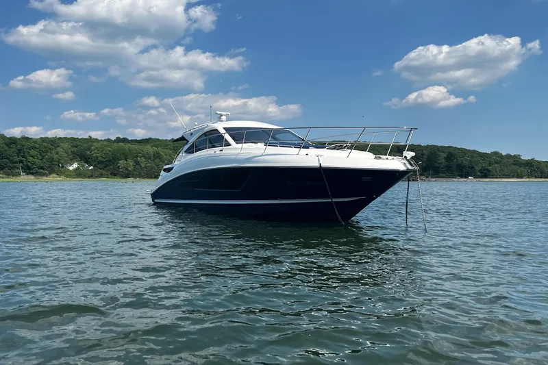 Slide: The Image of 2014 Sea Ray 510 Sundancer yacht on calm water under blue sky. - 2