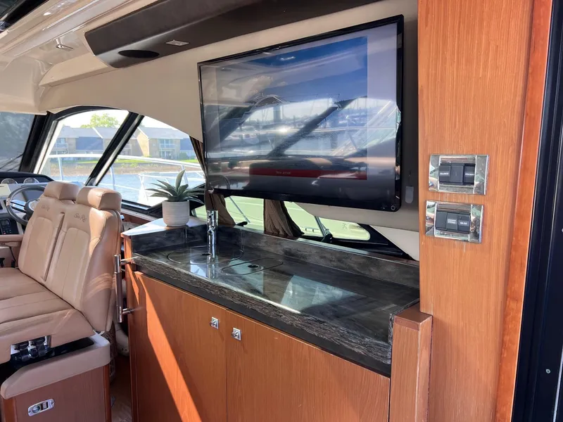 Slide: The Image of Luxurious interior of 2014 Sea Ray 510 Sundancer yacht with TV and seating area. - 23